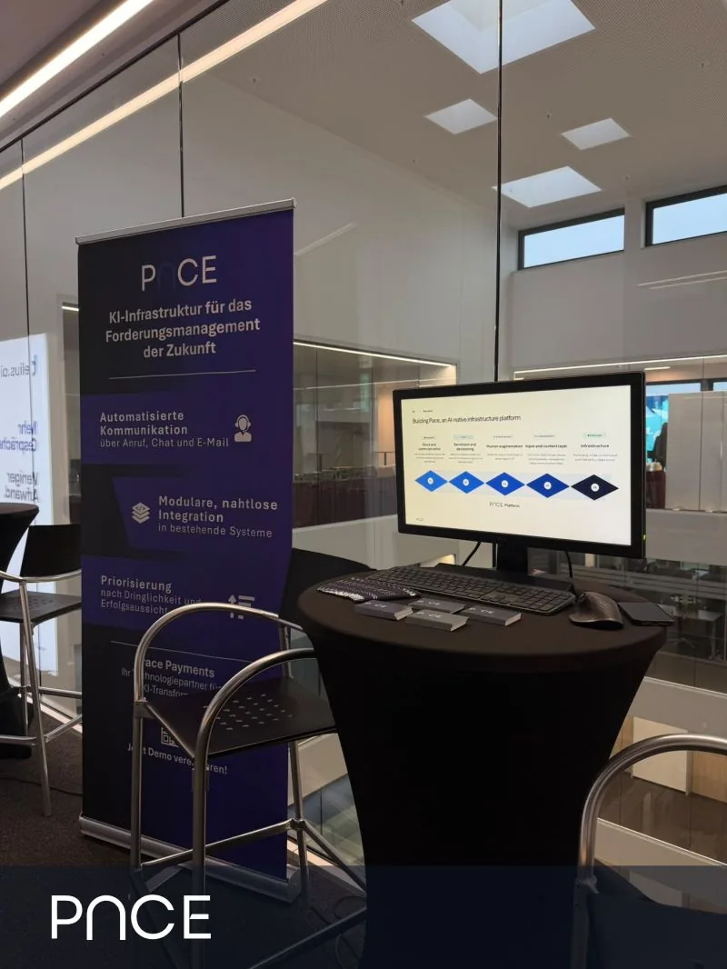 The Pace stand at the conference: a roll-up banner and a screen showing the platform